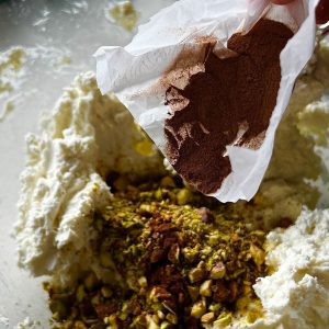 Adding cinnamon to the cranberry nut goat cheeseball